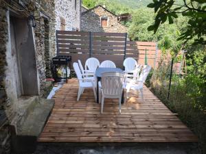 a table and chairs on a wooden deck at Maison de village in Sisco