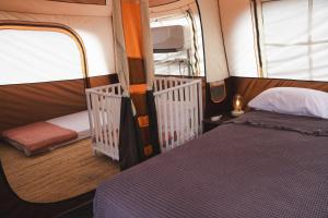 a bedroom with a bed and a window in a room at Mosh Achziv Beach in Gesher HaZiw