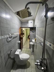 a bathroom with a toilet and a sink at L Arche in Douala