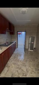 an empty kitchen with a sink and a refrigerator at L Arche in Douala