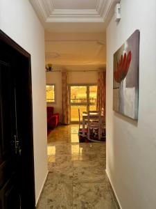 a hallway with a living room with a painting on the wall at L Arche in Douala