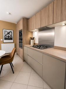 a kitchen with wooden cabinets and a stove top oven at Mason Gardens Home in Chilton