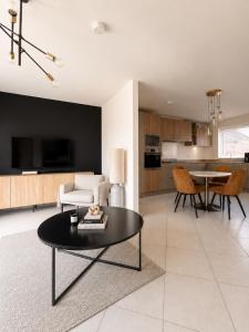 a living room with a table and a kitchen at Mason Gardens Home in Chilton +5 photos