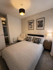 a bedroom with a large bed and a chair at Mason Gardens Home in Chilton
