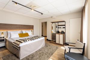 ein Schlafzimmer mit einem großen Bett und einem Spiegel in der Unterkunft Quality Hotel Augustin in Trondheim + 60 Fotos
