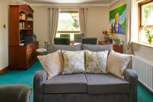 a living room with a couch with pillows at 2 Bedroom Apartment - Free Parking & Garden in Kilmessan