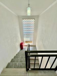 a stairway with a bench and a window at Sunrise House in Cholpon-Ata +12 photos