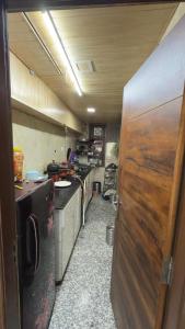 a kitchen in an rv with a wooden door at YogMaya Regency in Shimla