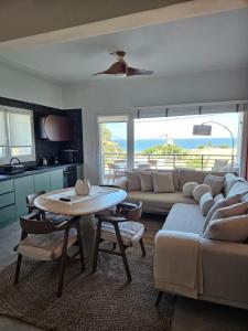 a living room with a couch and a table in it at Like home in Samothraki 2 in Kamariotissa