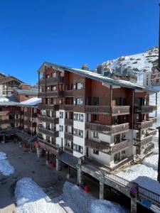 an apartment building with snow on the ground at Funiculaire collection in Tignes