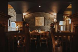 a dining room with a table and a stone wall at Hydro Hotel in Lisdoonvarna