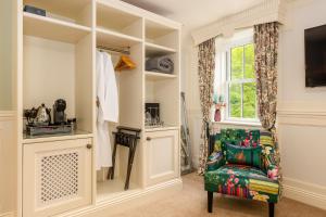 a living room with a chair and a window at Grange Manor in Grange Over Sands
