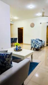 a living room with a couch and a table at Inverse Travels in Negombo