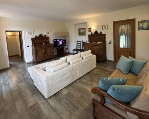 a living room with white couches and a television at Il Ranch in Baveno