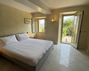 a bedroom with a large bed and a large window at Il Ranch in Baveno +39 photos