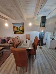 a living room with a table and chairs and a couch at Hexenhaus in Lüneburg