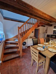 a kitchen and dining room with a table and a staircase at Hexenhaus in Lüneburg