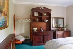 a bedroom with a wooden book shelf next to a bed at 2 Bedroom Apartment - Free Parking & Garden in Kilmessan