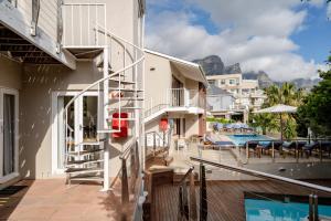 a balcony of a house with a swimming pool at Camps Bay Village in Cape Town