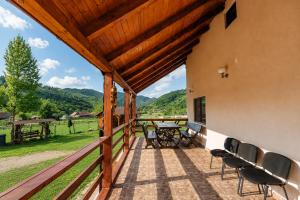 a patio with chairs and a table and a view at Casa LA CIOTIC in Săcuieu