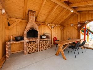 a room with a fireplace and a table in a cabin at Casa LA CIOTIC in Săcuieu