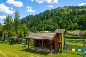a playground with a gazebo and a slide at Casa LA CIOTIC in Săcuieu