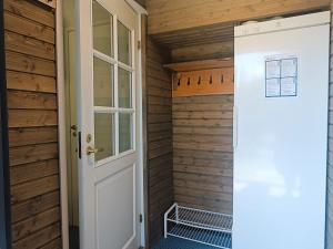 a door leading into a sauna with wooden walls at Revontuli 6 in Syöte
