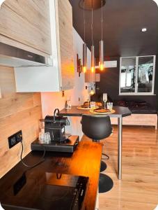 a kitchen with a table and a counter top at Secret Rock - Jaccuzi privé in La-Roche-en-Ardenne