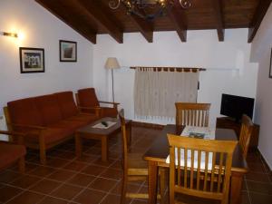 a living room with a couch and a table at Apartamentos El Pajar Alcala de la Selva in Alcalá de la Selva