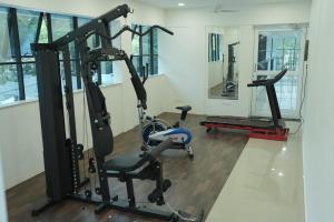 a gym with two tread machines and a treadmill at DHvillas in Wayanad