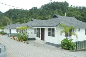 a white house with a black roof at DHvillas in Wayanad