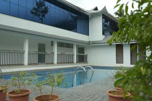 a building with a swimming pool in front of it at DHvillas in Wayanad