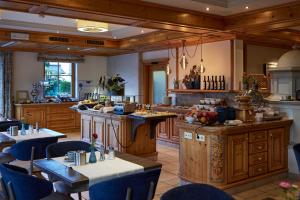 a large kitchen with wooden cabinets and tables at Hotel Gabi in Wals
