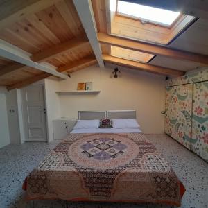 a bedroom with a large bed in a attic at Coccodrillo Fiorito in Viareggio