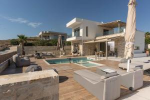 a villa with a swimming pool and a house at 3 Muses Luxury Villas in Kalamaki