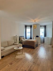 a living room with a bed and a couch at Excelsior in Graz +7 photos