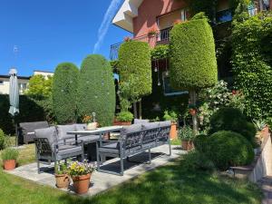 a patio with a table and benches in a yard at Dom Gościnny Relax in Rewal