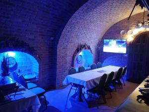 a dining room with a white table and chairs at Borház in Dédestapolcsány