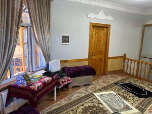 a living room with a couch and a table at Hotel KAMILA Prime in Samarkand
