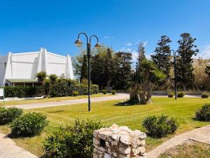 a park with a street light and a building at Cussorgia's House in Calasetta