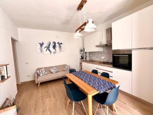 a kitchen and dining room with a table and chairs at Cussorgia's House in Calasetta