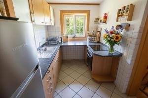 a kitchen with a sink and a vase of flowers at Frein Chalets - Kaltenbach in Frein