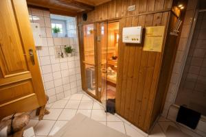 a bathroom with a wooden door in a room at Frein Chalets - Kaltenbach in Frein +21 photos
