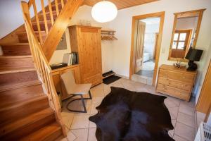 a room with a staircase and a desk and a chair at Frein Chalets - Kaltenbach in Frein