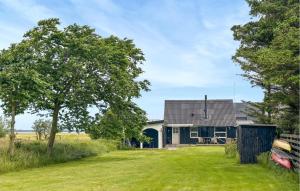 a house with a car parked in front of it at 3 Bedroom Pet Friendly Home In Roslev in Roslev +9 photos