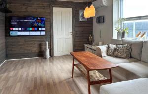 a living room with a couch and a table at 3 Bedroom Pet Friendly Home In Roslev in Roslev