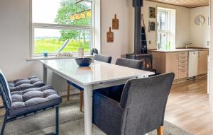 a kitchen with a white table and chairs at 3 Bedroom Pet Friendly Home In Roslev in Roslev