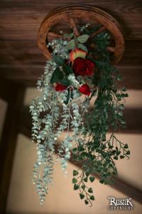 a bouquet of roses hanging from a ceiling at Rustik in Chailloué