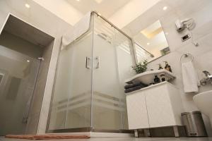 a bathroom with a shower and a sink at Epicenter Hotel Baku in Baku