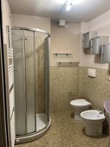 a bathroom with a shower and a toilet and a sink at Matteotti28 in Pesaro +41 photos